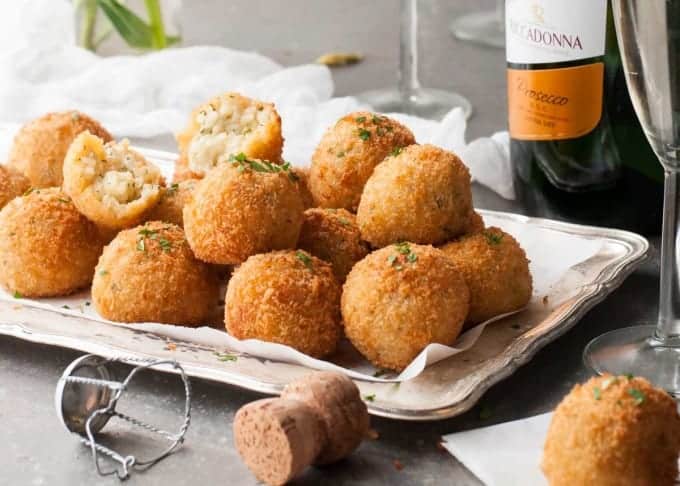 Cheesy Italian Arancini Balls -Creamy cheesy risotto rice, coated in panko and fried golden. The most EPIC Italian starter ever! recipetineats.com