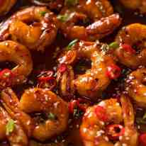 Close up of sticky Asian spicy garlic shrimp