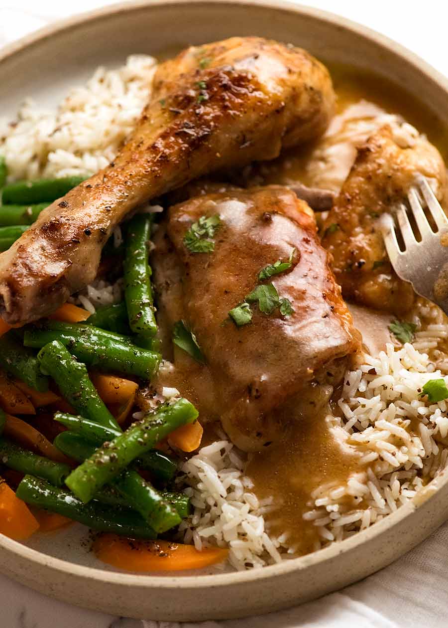 Gravy Baked Chicken served with seasoned rice and steamed vegetables