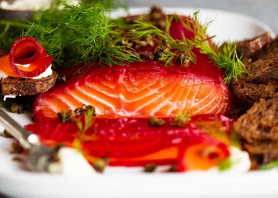 Close up photo showing the stunning colours of Beetroot Cured Salmon (Gin or Vodka, Salmon Gravlax)