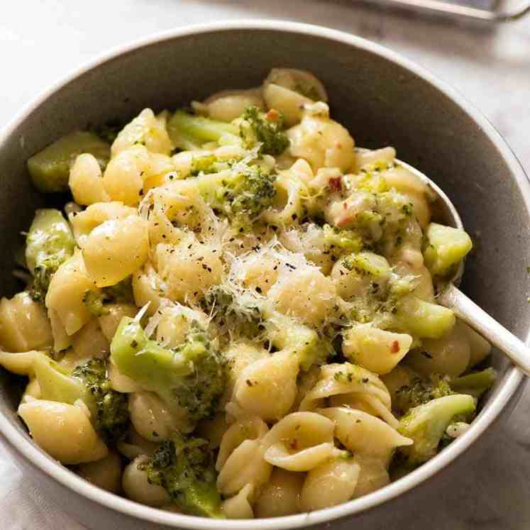 Cheesy broccoli pasta in a rustic blue bowl, ready to be eaten