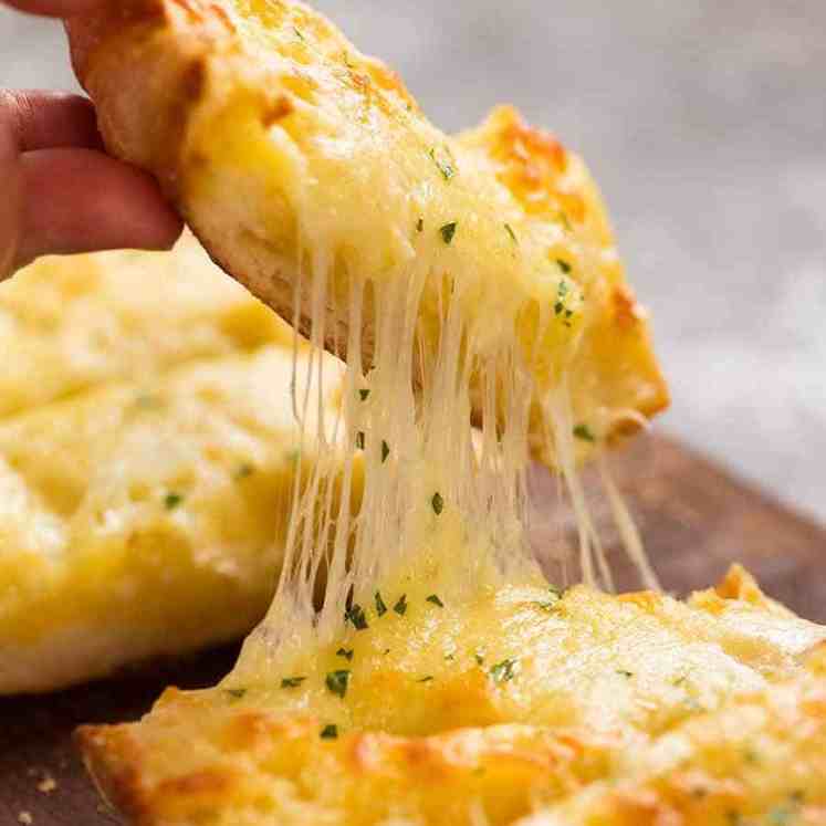 Cheese stretch picking up piece of Quick Cheesy Garlic Bread