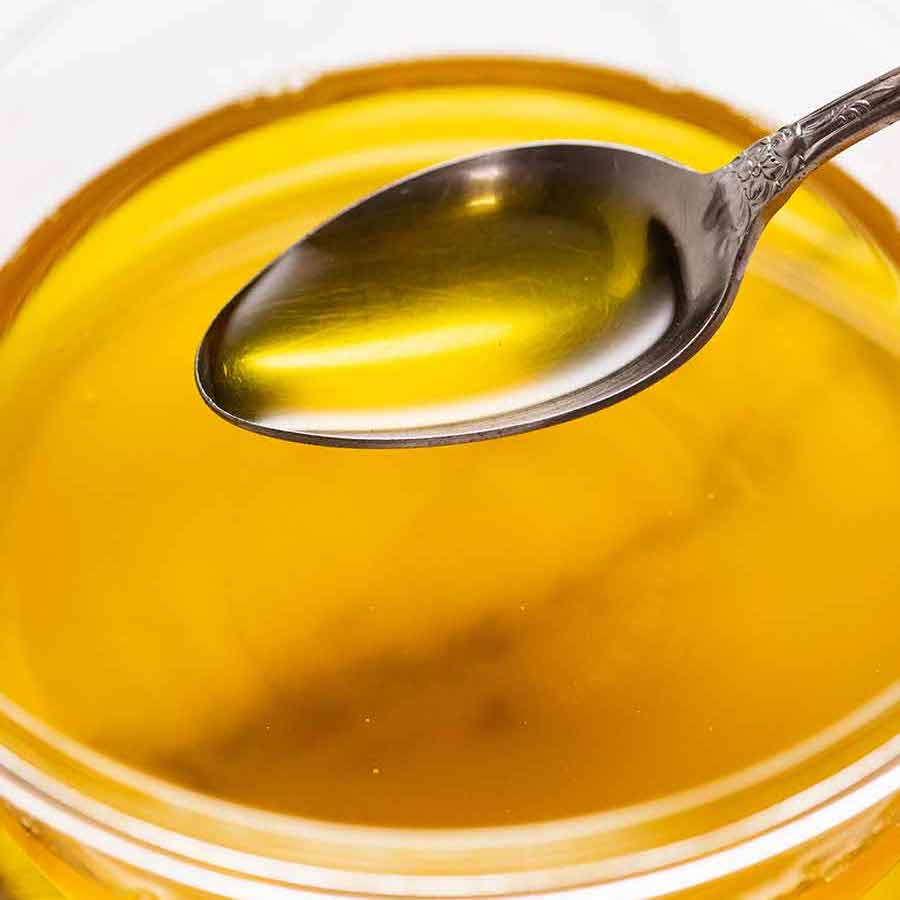 Spoon scooping up homemade ghee