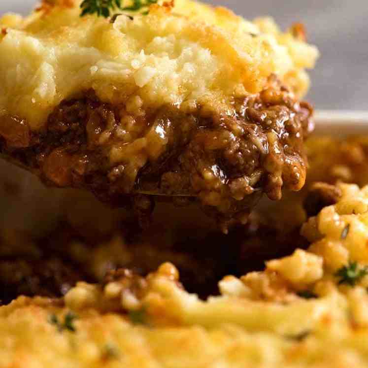 Close up of Cottage Pie being scooped out of baking dish, ready to be served