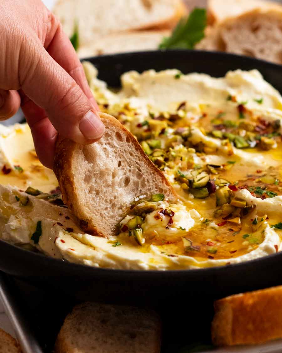 Dipping bread into Creamy Feta Dip