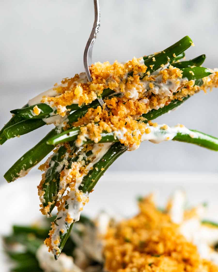 Fork picking up Green beans with a mountain of panko