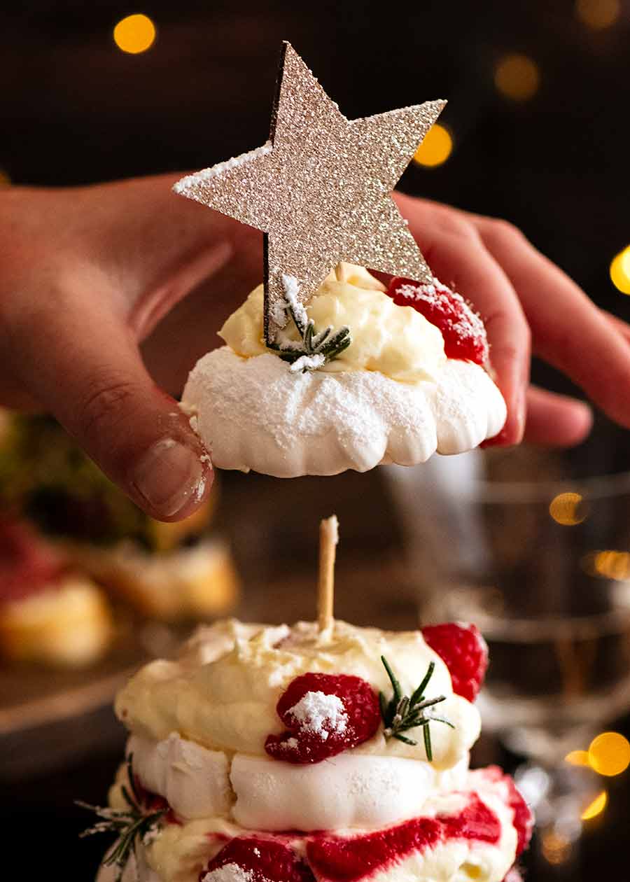 Handing picking up top layer of Pavlova Christmas Tree Dessert