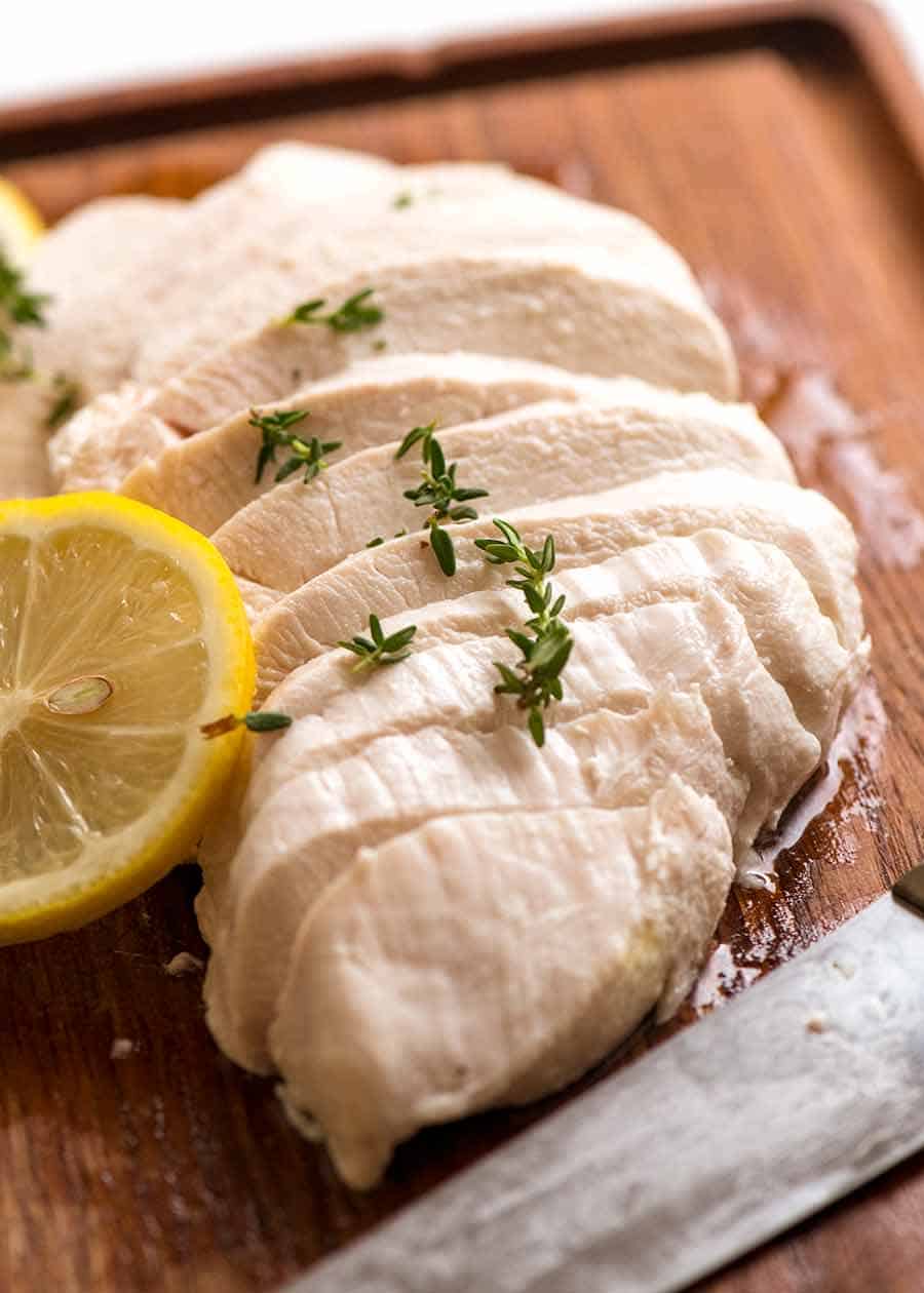 Sliced Poached Chicken breast on a cutting board