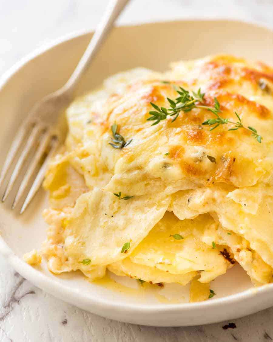 Close up of bowl with Potatoes au gratin (Dauphinoise Potatoes), ready to be eaten