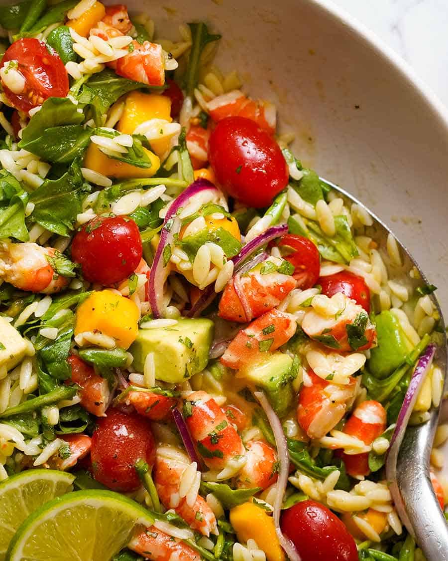 Close up overhead photo of Prawn Mango Avocado Summer Salad with Lime Dressing in a bowl, ready to be served